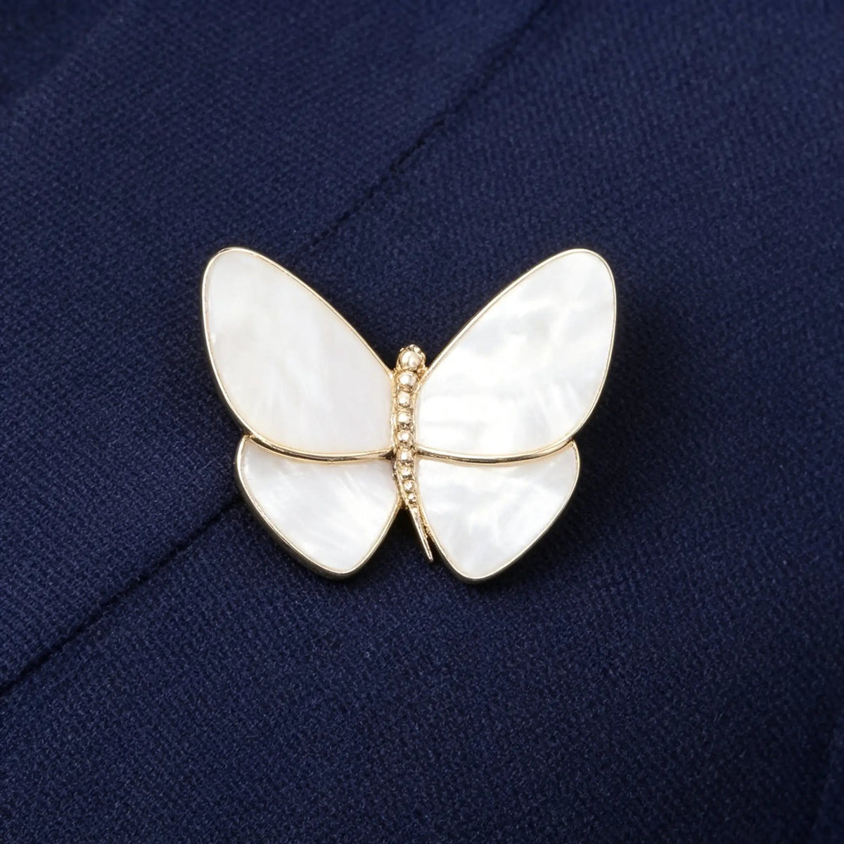This is a gold, mother-of-pearl, and diamond brooch from Van Cleef & Arpels' Butterfly collection.